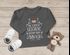 Baby Langarmshirt mit Spruch Weihnachten Das schönste Geschenk unterm Baum bin ich Babyshirt Jungen Mädchen Moonworks®preview